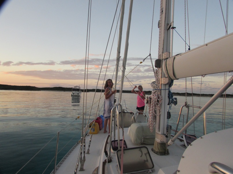 Katharine and Cynthia blowing the conch shell at sunset
